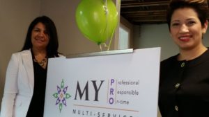 Milady Perez (left) and Yessenia Blanco pause Friday during the opening of their business, MY PRO Multi-Services