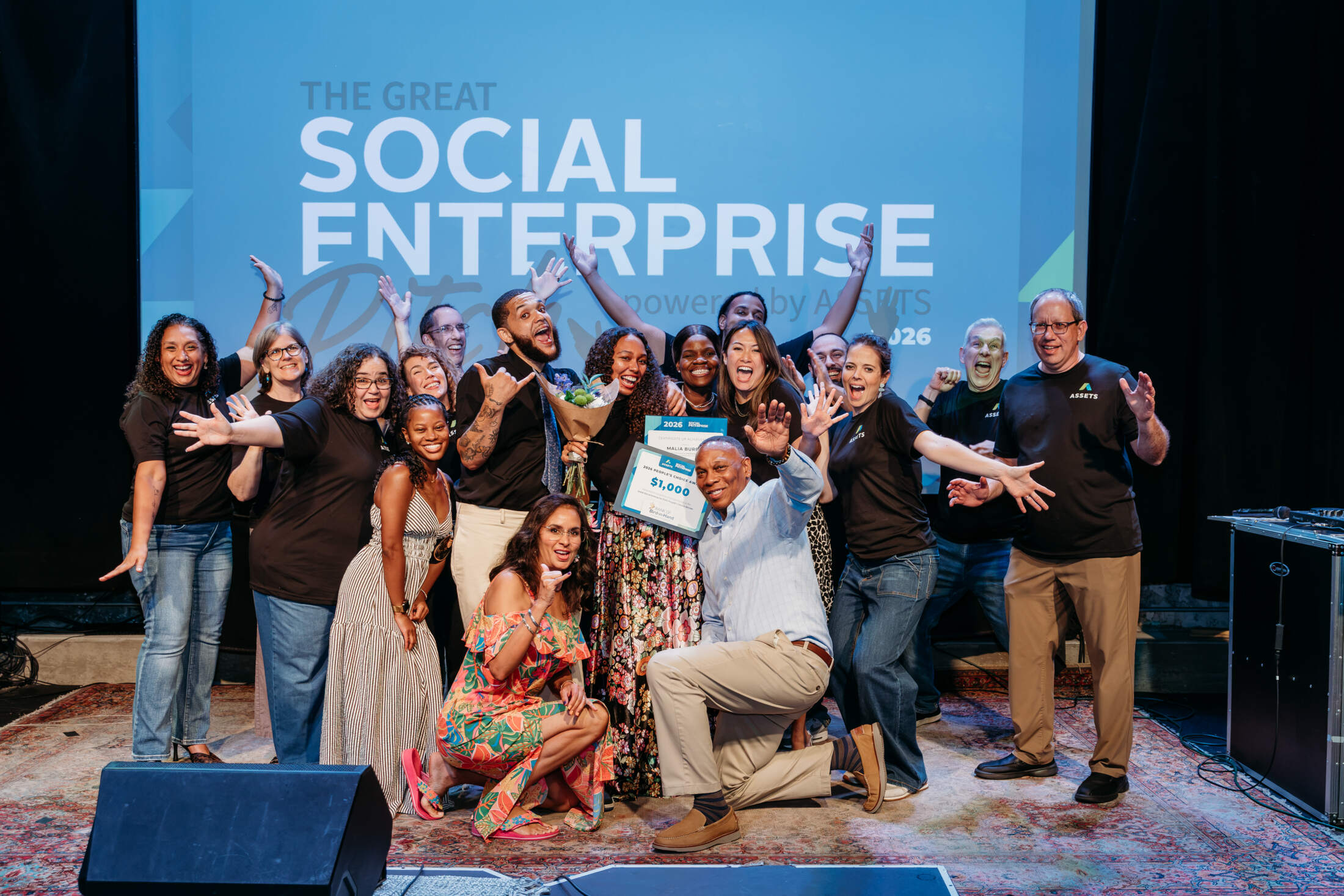 Pitch finalists and the ASSETS' team having fun on stage at the 2026 Great Social Enterprise Pitch